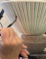 Speeded up film of a Rye Pottery Striped salad bowl being made - from a lump of clay to the stripes being painted