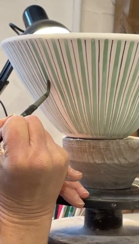 Speeded up film of a Rye Pottery Striped salad bowl being made - from a lump of clay to the stripes being painted freehand