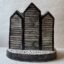 Reverse view of hand made ceramic figure depicting iconic local black weatherboard fishing huts 1
