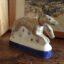hand made ceramic hounds figurine sculpture showing two dogs made to accompany of The Monk from chaucer's canterbury Tales collection with a matching base and decoration