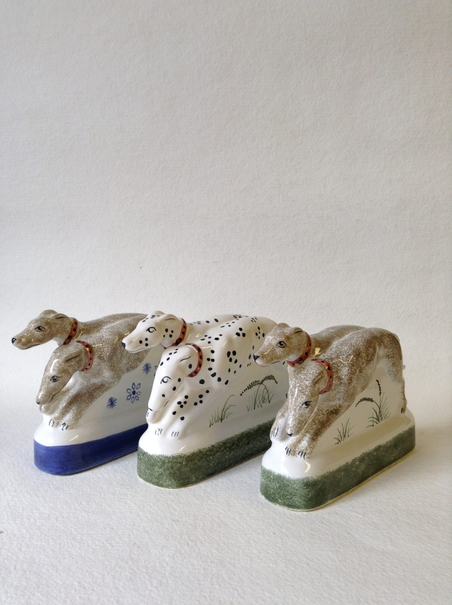 Hand made ceramic hounds figurine sculpture showing two dogs three colourways including Dalmatians and a companion pair made for the Chaucer's Canterbury Tales figure of the Monk