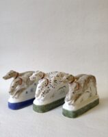 Hand made ceramic hounds figurine sculpture showing two dogs three colourways including Dalmatians and a companion pair made for the Chaucer's Canterbury Tales figure of the Monk